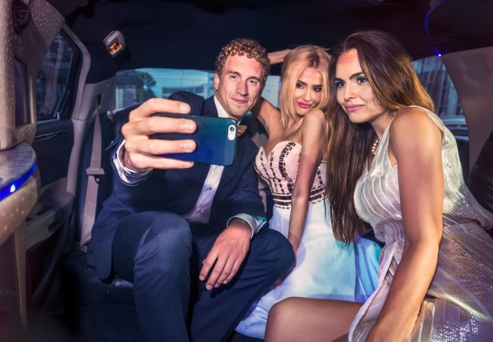 Taking a selfie in the back of a limousine